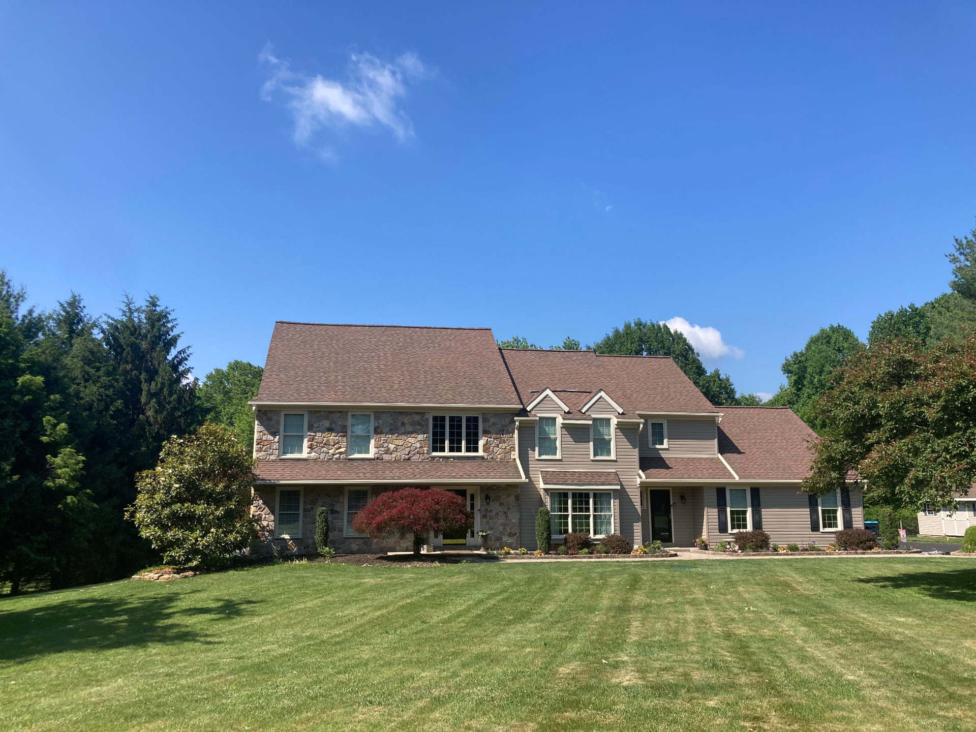 After soft-wash roof cleaning with shingles restored to their original color
